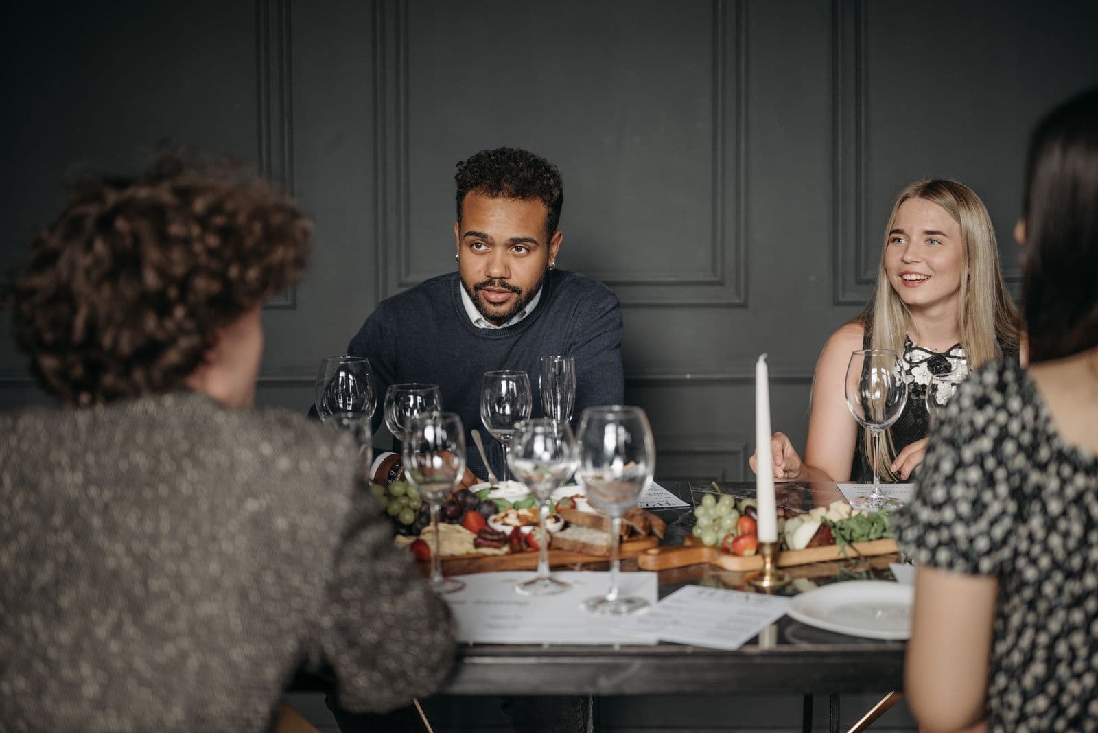 Friends talking across a dinner table